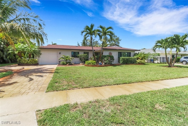 1015 El Valle Ave, Fort Myers, FL 33919 - single story home with a garage, decorative driveway, and stucco siding