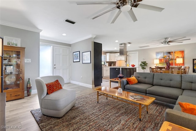 1015 El Valle Ave, Fort Myers, FL 33919 - living room featuring a ceiling fan, light wood-style floors, crown molding, and recessed lighting