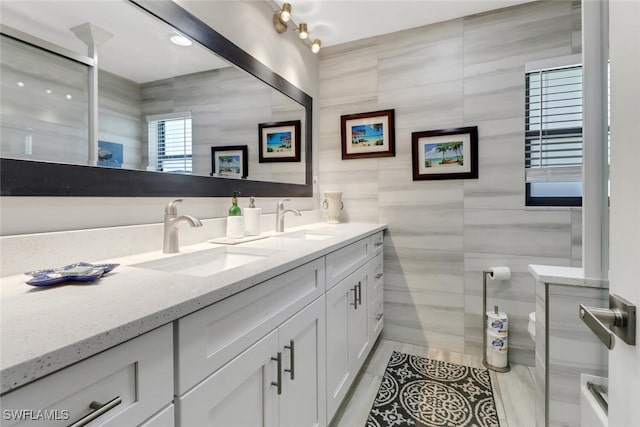 1015 El Valle Ave, Fort Myers, FL 33919 - bathroom with double vanity, tile walls, a shower, and tile patterned floors