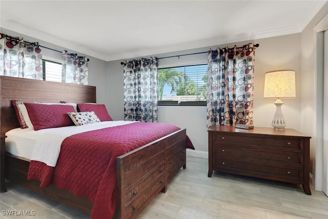 1015 El Valle Ave, Fort Myers, FL 33919 - bedroom with crown molding and light wood-style flooring