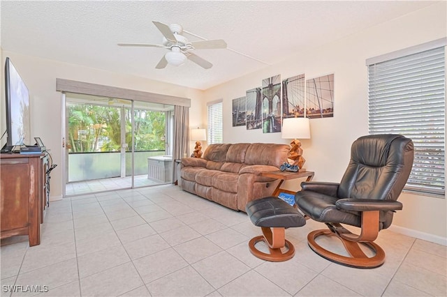4217 SE 19th Ave Unit 110, Cape Coral, FL 33904 - living area with a ceiling fan, light tile patterned flooring, and a textured ceiling