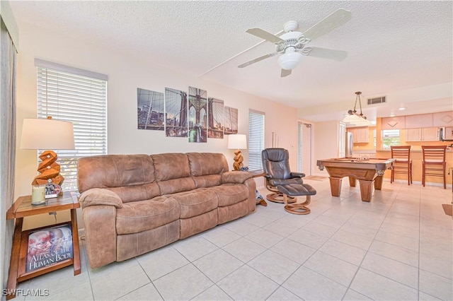 4217 SE 19th Ave Unit 110, Cape Coral, FL 33904 - living room featuring light tile patterned floors, billiards table, a textured ceiling, and a ceiling fan