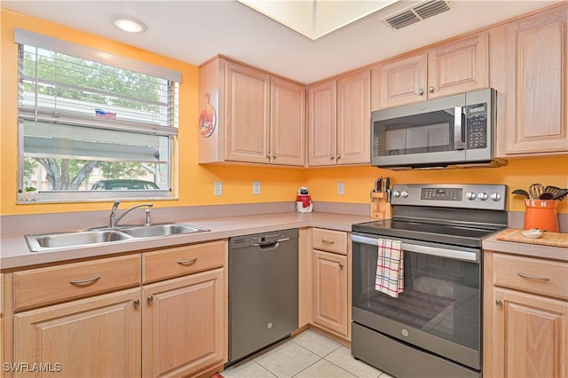 4217 SE 19th Ave Unit 110, Cape Coral, FL 33904 - kitchen with stainless steel appliances, light brown cabinets, light countertops, light tile patterned flooring, and recessed lighting