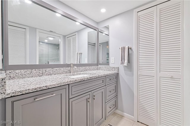 4217 SE 19th Ave Unit 110, Cape Coral, FL 33904 - full bath with a closet, vanity, a stall shower, tile patterned flooring, and recessed lighting