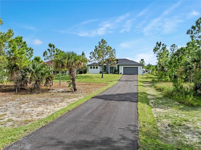 3614 22nd Ave NE, Naples, FL 34120 - view of front of home featuring a front yard, driveway, and an attached garage