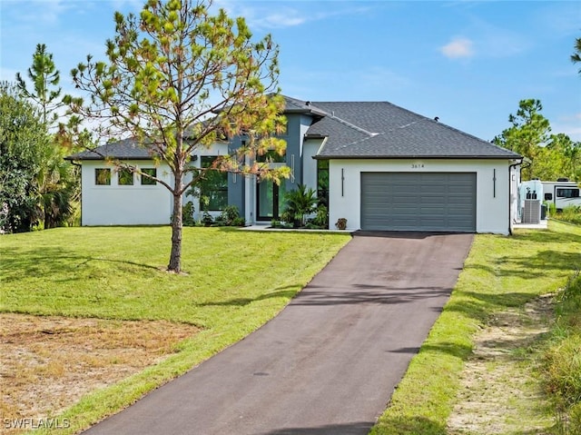 3614 22nd Ave NE, Naples, FL 34120 - view of front of home with stucco siding, a garage, driveway, a front yard, and roof with shingles