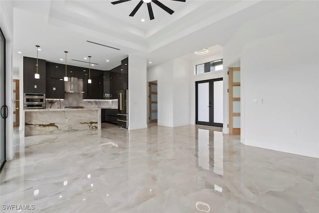3614 22nd Ave NE, Naples, FL 34120 - unfurnished living room featuring light marble finish flooring, ceiling fan, a tray ceiling, a high ceiling, and recessed lighting