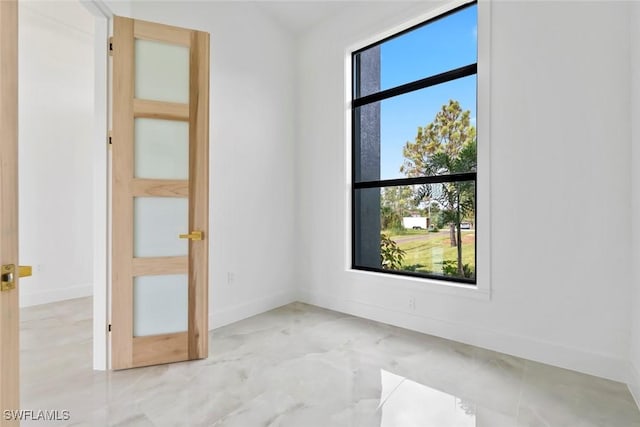 3614 22nd Ave NE, Naples, FL 34120 - unfurnished room featuring baseboards and marble finish floors