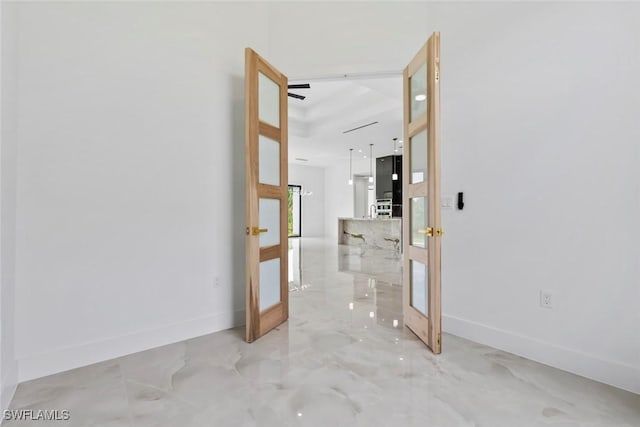 3614 22nd Ave NE, Naples, FL 34120 - hallway featuring french doors and light marble finish flooring