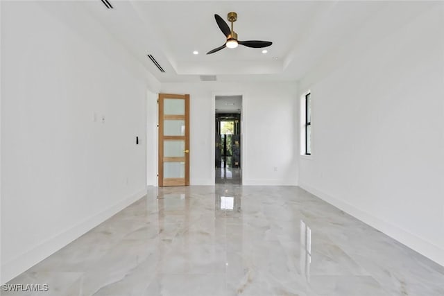 3614 22nd Ave NE, Naples, FL 34120 - empty room with light marble finish floors, ceiling fan, a raised ceiling, and recessed lighting