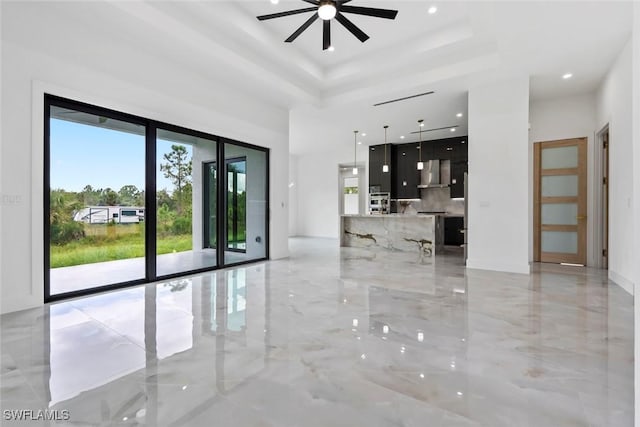 3614 22nd Ave NE, Naples, FL 34120 - spare room featuring ceiling fan, light marble finish floors, a raised ceiling, recessed lighting, and a high ceiling