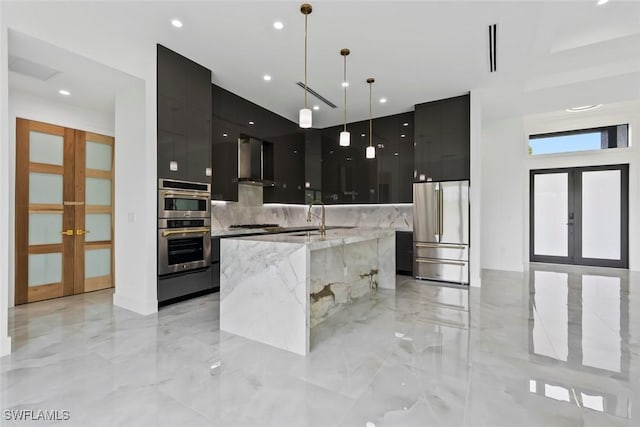 3614 22nd Ave NE, Naples, FL 34120 - kitchen with modern cabinets, stainless steel appliances, french doors, wall chimney range hood, and recessed lighting