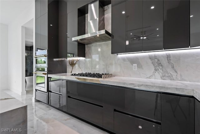 3614 22nd Ave NE, Naples, FL 34120 - kitchen with wall chimney range hood, modern cabinets, stainless steel appliances, backsplash, and dark cabinets