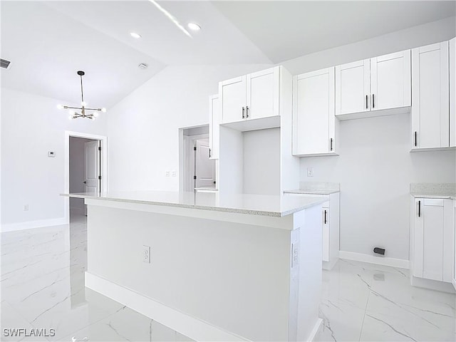 5001 Bywood St, Lehigh Acres, FL 33971 - kitchen featuring light marble finish flooring, a kitchen island, lofted ceiling, white cabinetry, and light countertops