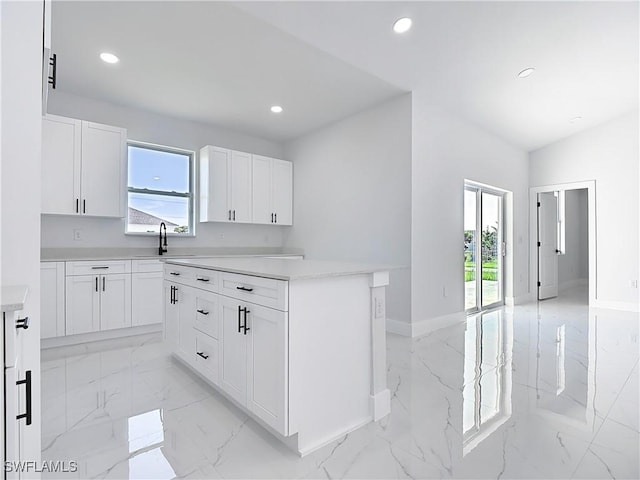 5001 Bywood St, Lehigh Acres, FL 33971 - kitchen featuring light marble finish floors, white cabinets, recessed lighting, light countertops, and a kitchen island