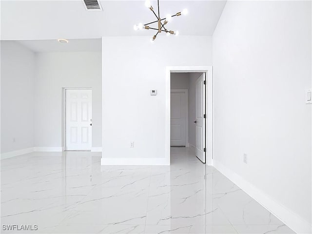 5001 Bywood St, Lehigh Acres, FL 33971 - empty room featuring a chandelier and light marble finish flooring