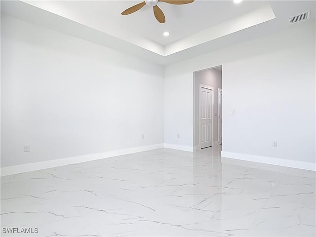 5001 Bywood St, Lehigh Acres, FL 33971 - unfurnished room with a tray ceiling, recessed lighting, ceiling fan, and light marble finish floors