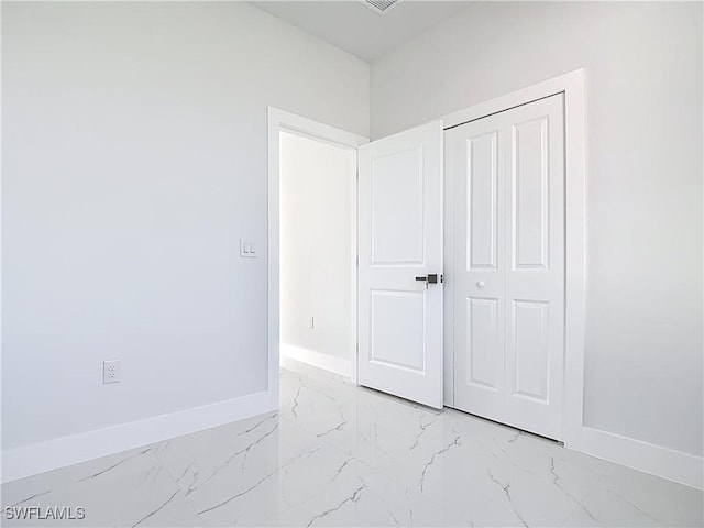 5001 Bywood St, Lehigh Acres, FL 33971 - unfurnished bedroom with light marble finish flooring and a closet