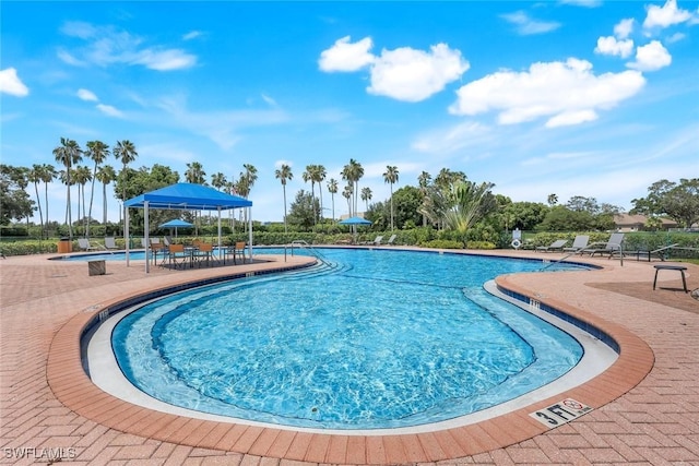 6956 Lone Oak Blvd, Naples, FL 34109 - community pool with a patio area