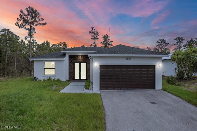 3525 43rd Ave NE, Naples, FL 34120 - view of front of home featuring asphalt driveway, stucco siding, an attached garage, a lawn, and roof with shingles