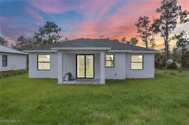 3525 43rd Ave NE, Naples, FL 34120 - back of house with a lawn and stucco siding