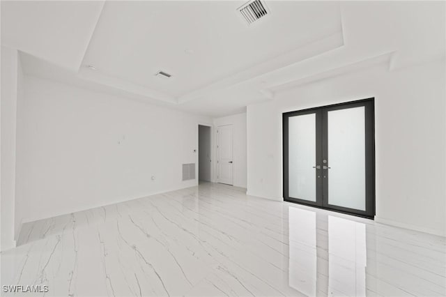 3525 43rd Ave NE, Naples, FL 34120 - unfurnished room featuring a tray ceiling, marble finish flooring, and french doors