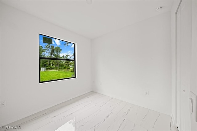 3525 43rd Ave NE, Naples, FL 34120 - unfurnished room with marble look tile flooring and a smoke detector