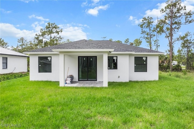 3525 43rd Ave NE, Naples, FL 34120 - back of house with a yard, stucco siding, and a shingled roof