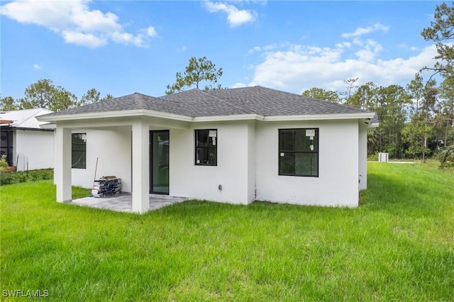 3525 43rd Ave NE, Naples, FL 34120 - back of property featuring a patio, a yard, roof with shingles, and stucco siding