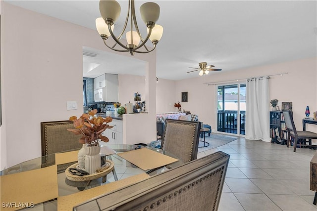 3284 Royal Canadian Trce Unit 4, Fort Myers, FL 33907 - dining space featuring a chandelier, ceiling fan, and light tile patterned floors