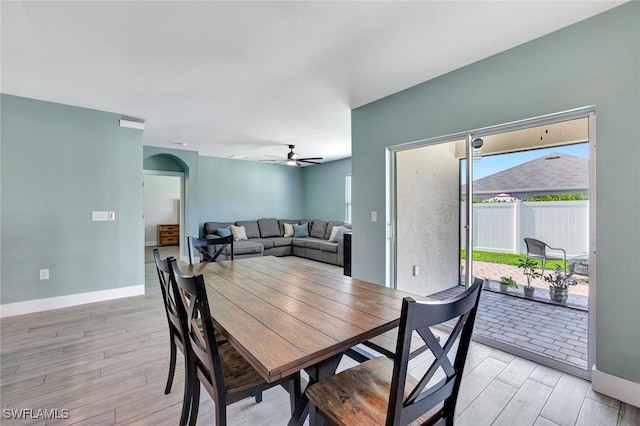 692 Hadley St E, Naples, FL 34104 - dining area featuring light wood-type flooring, plenty of natural light, a ceiling fan, and arched walkways