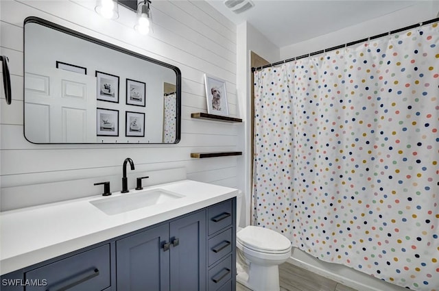 692 Hadley St E, Naples, FL 34104 - bathroom featuring vanity, a shower with shower curtain, wood finished floors, and wood walls