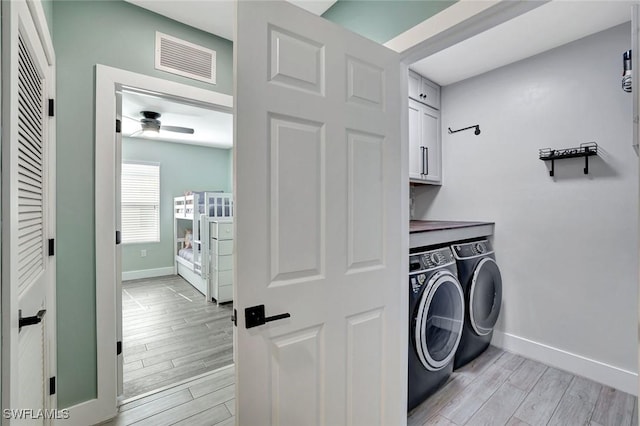 692 Hadley St E, Naples, FL 34104 - laundry area with cabinet space, washer and dryer, a ceiling fan, and light wood-style floors