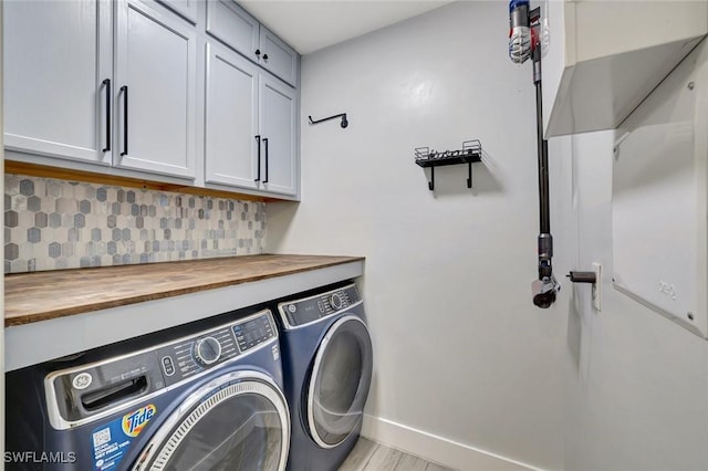 692 Hadley St E, Naples, FL 34104 - laundry room featuring washing machine and dryer, cabinet space, and light wood finished floors