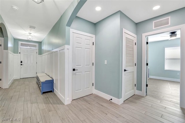 692 Hadley St E, Naples, FL 34104 - hallway featuring arched walkways and light wood-style flooring