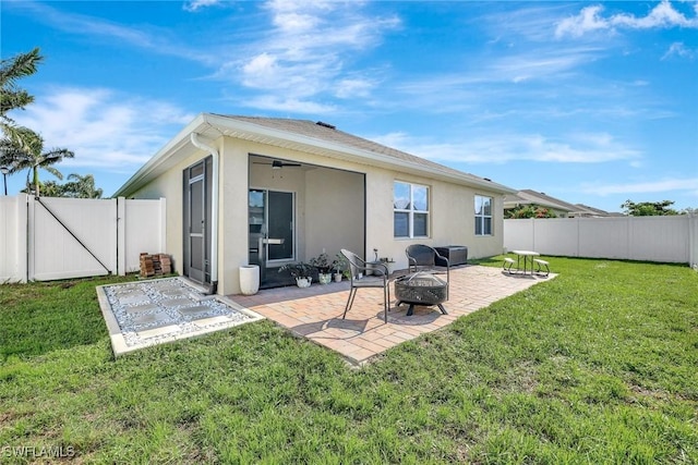 692 Hadley St E, Naples, FL 34104 - rear view of property featuring a fire pit, a gate, a patio, stucco siding, and a fenced backyard