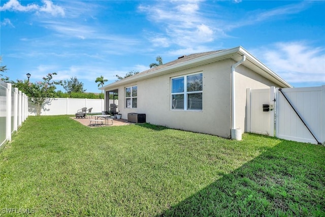 692 Hadley St E, Naples, FL 34104 - rear view of house with stucco siding, a fenced backyard, a patio, and a gate