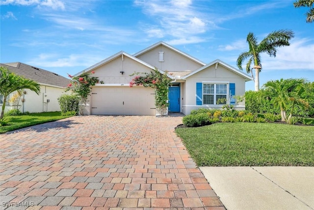692 Hadley St E, Naples, FL 34104 - ranch-style house with an attached garage, decorative driveway, stucco siding, and a front yard