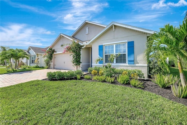 692 Hadley St E, Naples, FL 34104 - view of front of home with decorative driveway, a front lawn, a garage, and stucco siding