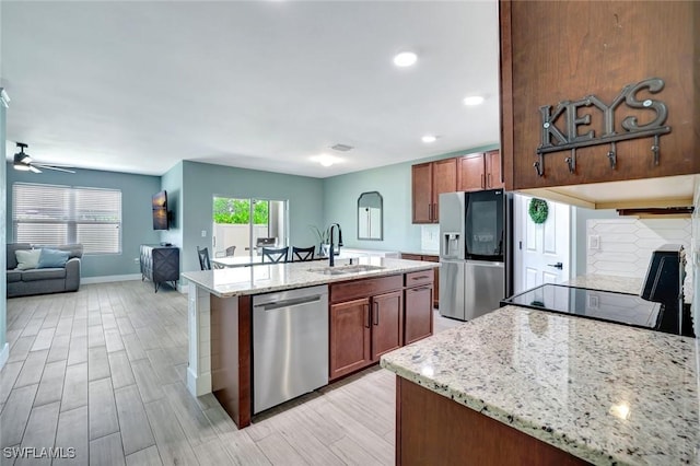 692 Hadley St E, Naples, FL 34104 - kitchen featuring stainless steel appliances, light wood-type flooring, ceiling fan, open floor plan, and recessed lighting