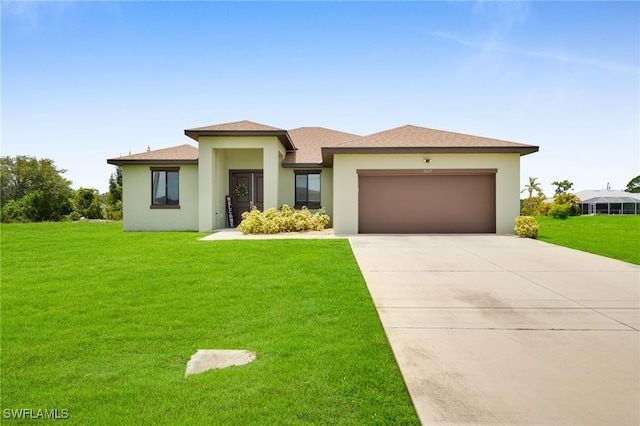 2622 SW 5th St, Cape Coral, FL 33991 - prairie-style house featuring stucco siding, a front yard, a garage, and concrete driveway