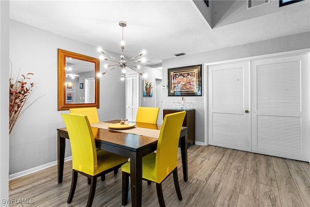 9761 Maplecrest Cir, Lehigh Acres, FL 33936 - dining space featuring a chandelier and light wood-style flooring