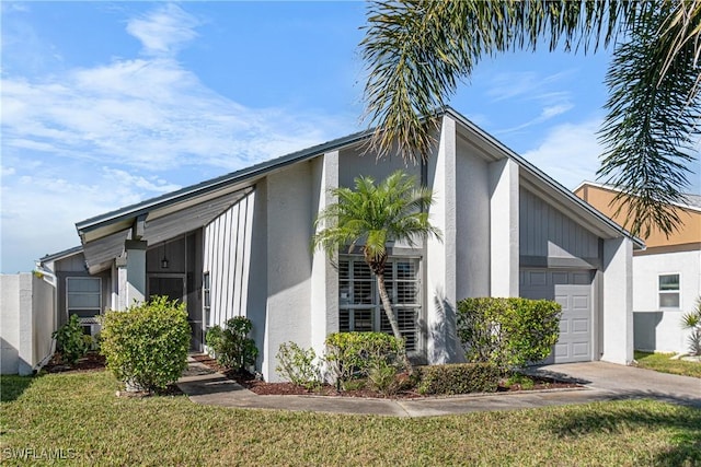9761 Maplecrest Cir, Lehigh Acres, FL 33936 - view of side of property featuring a garage, stucco siding, concrete driveway, and a lawn