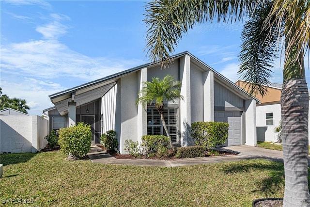 9761 Maplecrest Cir, Lehigh Acres, FL 33936 - view of side of home with an attached garage, a lawn, stucco siding, and driveway