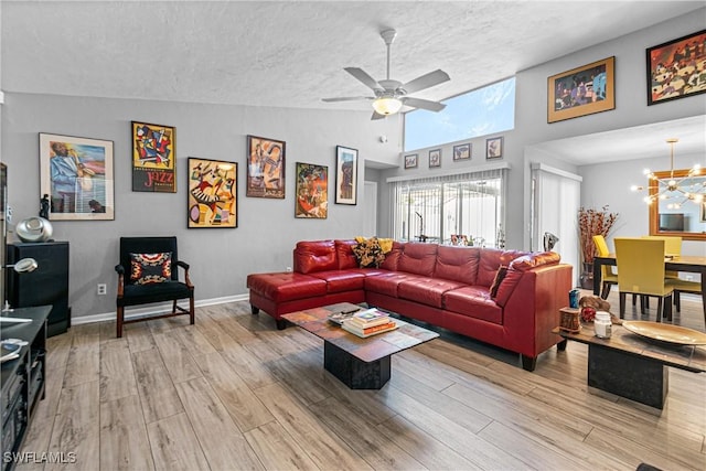 9761 Maplecrest Cir, Lehigh Acres, FL 33936 - living room with a textured ceiling, wood finished floors, a chandelier, a ceiling fan, and vaulted ceiling