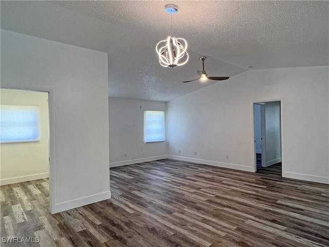 625 SE 35th Ter, Cape Coral, FL 33904 - empty room featuring a textured ceiling, a ceiling fan, dark wood finished floors, a chandelier, and vaulted ceiling