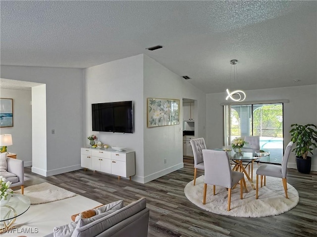 625 SE 35th Ter, Cape Coral, FL 33904 - dining room featuring a textured ceiling, dark wood-style floors, and vaulted ceiling