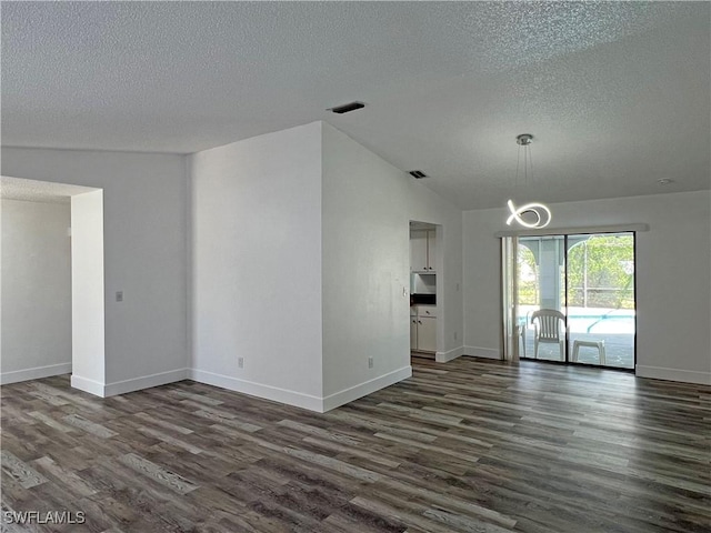 625 SE 35th Ter, Cape Coral, FL 33904 - unfurnished living room with dark wood-type flooring, a textured ceiling, and lofted ceiling