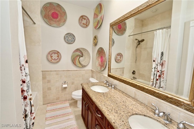 2855 Coach House Way, Naples, FL 34105 - bathroom featuring double vanity, shower / bath combination with curtain, tile walls, a wainscoted wall, and tile patterned flooring