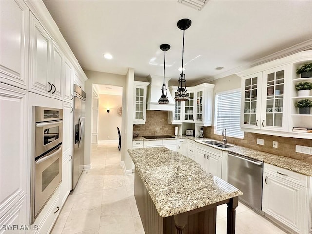2855 Coach House Way, Naples, FL 34105 - kitchen featuring appliances with stainless steel finishes, a center island, decorative backsplash, open shelves, and white cabinetry